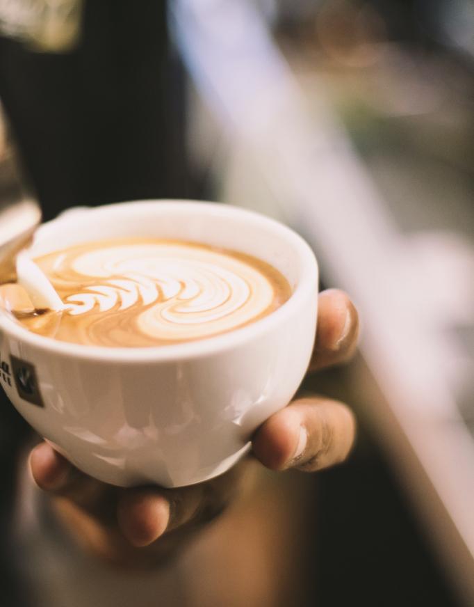 Transcend latte with latte art being poured into it.
